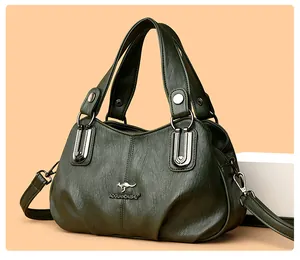 Detail showing the green leather texture and kangaroo logo on the stylish handbag
