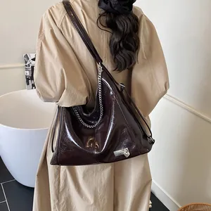 Deep brown oil wax leather tote bag with silver chain and heart charm detail