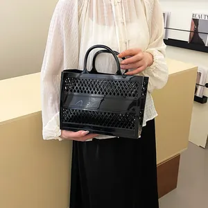 Black hollow cutout jelly basket tote bag with diamond grid pattern and double handles