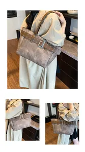 Detail der Vintage-Tote-Bag mit Schnallenriemen und strukturierter Steinoberfläche