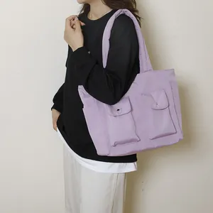 Large lavender canvas tote bag with multi-pockets and quilted strap on shoulder