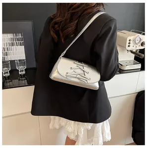 Rear view of silver metallic crossbody bag with lace skirt and black blazer outfit