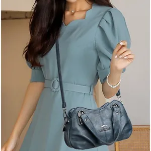Classic dark teal vintage leather tote bag for women with kangaroo logo detail