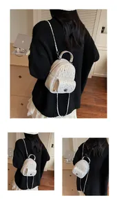 Detail of white mini backpack with quilted pattern, rhinestone accents and silver chain strap