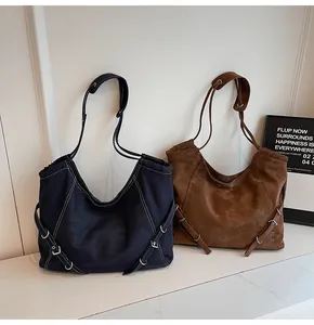 Detail of large tote bags in denim and suede finish with silver ring buckle accents