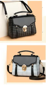 Detail view of retro plaid crossbody bags in black and light blue with gold metal locks