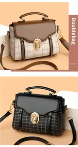 Detail of vintage plaid crossbody bag featuring wavy flap edge and gold swivel lock