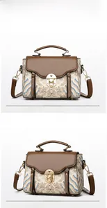 Vue détaillée du sac à main en tissu brodé vintage avec bordure en cuir et fermoir doré