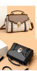 Detail view of vintage plaid crossbody bags with gold metal locks and contrast handles