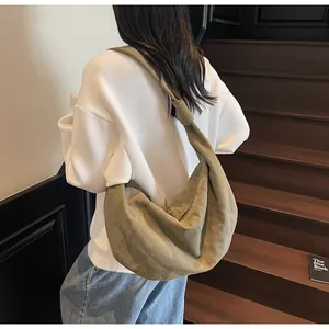 Detail of the oversized army green crossbody dumpling bag with unique knotted strap design