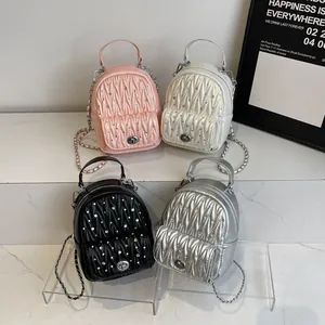 Chic quilted backpack with chain straps and rhinestone logo in pink, white, black, and silver