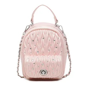 Pink mini backpack with quilted pattern and rhinestone embellishments on front pocket