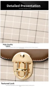 Macro detail of plaid canvas fabric texture and light gold metal press lock closure