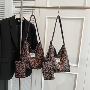 Vintage leopard print tote bag with matching pouch on a display rack for commuters