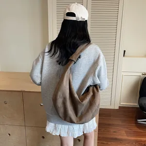 Deep brown oversized canvas dumpling bag with quilted stitch detail for casual crossbody wear