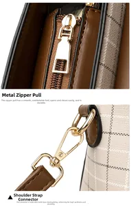 Detail of high-quality gold plating metal zipper and buckle on a vintage checkered crossbody bag