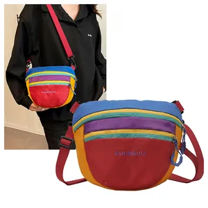 Nylon crossbody bag detail with multi-color splicing and adjustable red strap