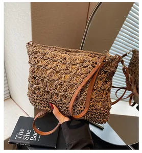 Macro detail of hand-woven hollow floral patterns and leather handles on straw tote bag