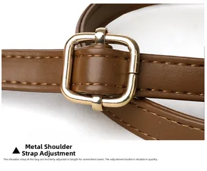 Close-up of adjustable brown leather strap with polished golden metal buckle and texture