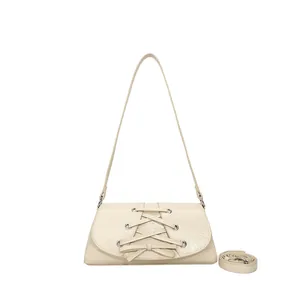 Fashionable beige crossbody bag with bow tie detail and adjustable shoulder straps