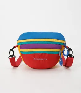 Detail of multi-color crossbody bag featuring durable fabric and adjustable buckle strap