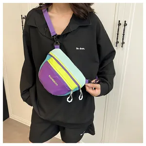 Detail of multi-color nylon chest bag with adjustable strap and geometric zipper pulls
