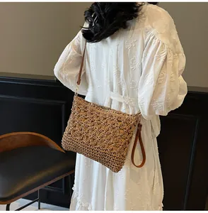Detail view of woven beach tote showing natural fiber pattern and brown leather straps