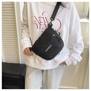 Detail of waterproof black nylon sports chest bag with metal zipper and durable strap