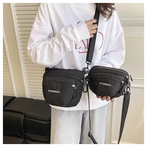 Detail of waterproof black nylon chest bags in two sizes with adjustable straps