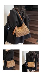 Detail of floral hollow woven pattern and brown leather strap on large straw tote bag