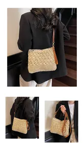Detail of hand-woven beige straw tote with 3D crochet floral patterns and leather straps