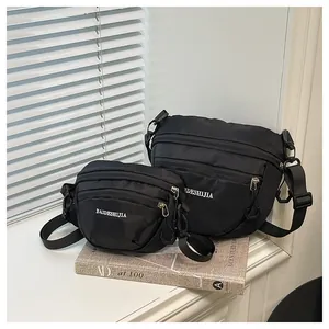Close-up of dual-size waterproof nylon chest bags with premium silver zippers and textures