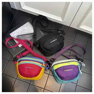 Detailed flat lay of water-resistant nylon crossbody bags in black and multicolor patch designs