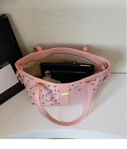 Interior view of spacious pink cherry print tote bag holding tablets and essentials