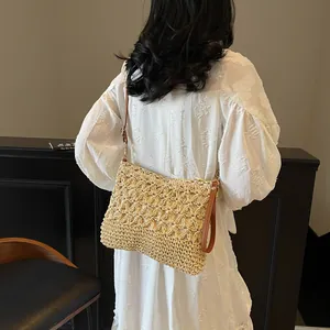 Chic beige straw tote bag with floral hollow weave and adjustable brown leather strap