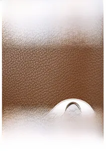 Close-up of brown lychee grain leather texture and durable handle detail on tote bag