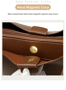 Detail of dark brown leather tote featuring a golden magnetic buckle and secure zipper