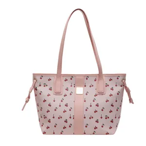 Pink tote bag with cherry print and adjustable drawstrings on a white background