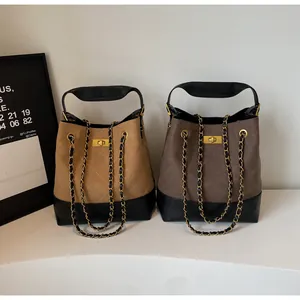 Detail of vintage quilted tote bags with gold chain straps and sleek twist-lock closures
