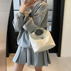 Chic solid color large capacity handbag with round cutout handle and silver logo plate