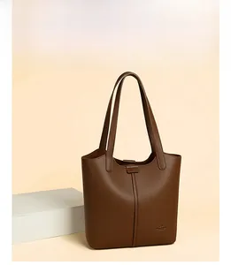 Close-up of deep brown pebbled leather tote bag with elegant vertical stitching details