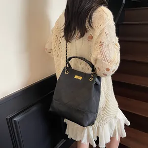 Vintage black quilted tote bag with chain strap and gold twist lock for daily commute