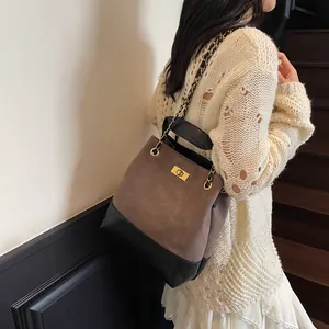 Vintage quilted leather tote bag with chain strap and gold twist lock in brown and black