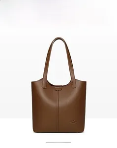 Close-up of deep brown lychee texture leather tote bag with vertical stitching and logo