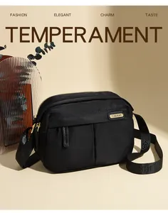 Detailed view of black nylon crossbody bag with golden hardware and textured strap
