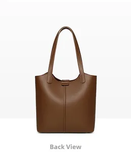 Detailed back view of a brown pebbled leather tote bag with long handles and stitching