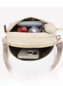 Detailed interior of beige crossbody bag showing high capacity for daily essentials