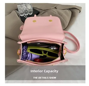 Pink leather bag internal capacity showing sunglasses and wallet storage detail