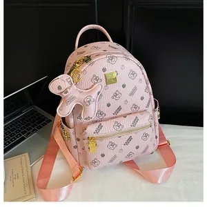 Vue détaillée du mini sac à dos rose avec ours, fermetures dorées et pendentif