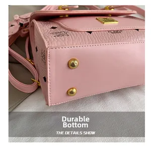 Close-up of pink textured leather backpack featuring bottom protective metal studs